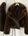 Brown fur coat on a mannequin against a white background