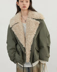 Person wearing a green jacket with a beige fur collar on a white background