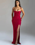 Red evening gown with a high slit on a gray background